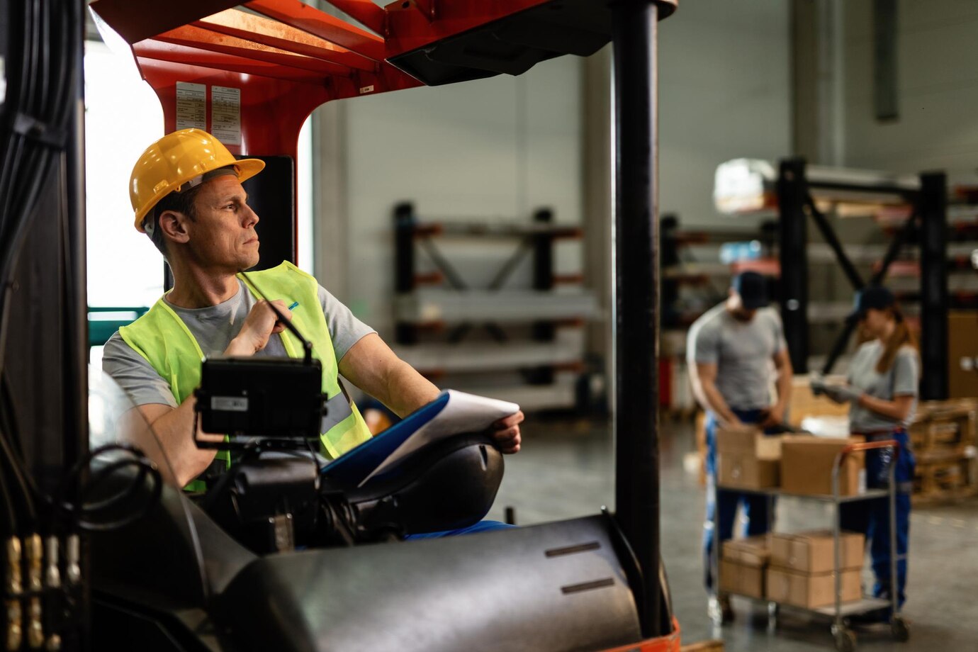 warehouse-forklift-driver-thinking-something-while-going-through-delivery-schedule-industrial-building_637285-4202 warehouse-forklift-driver-thinking-something-while-going-through-delivery-schedule-industrial-building_637285-4202